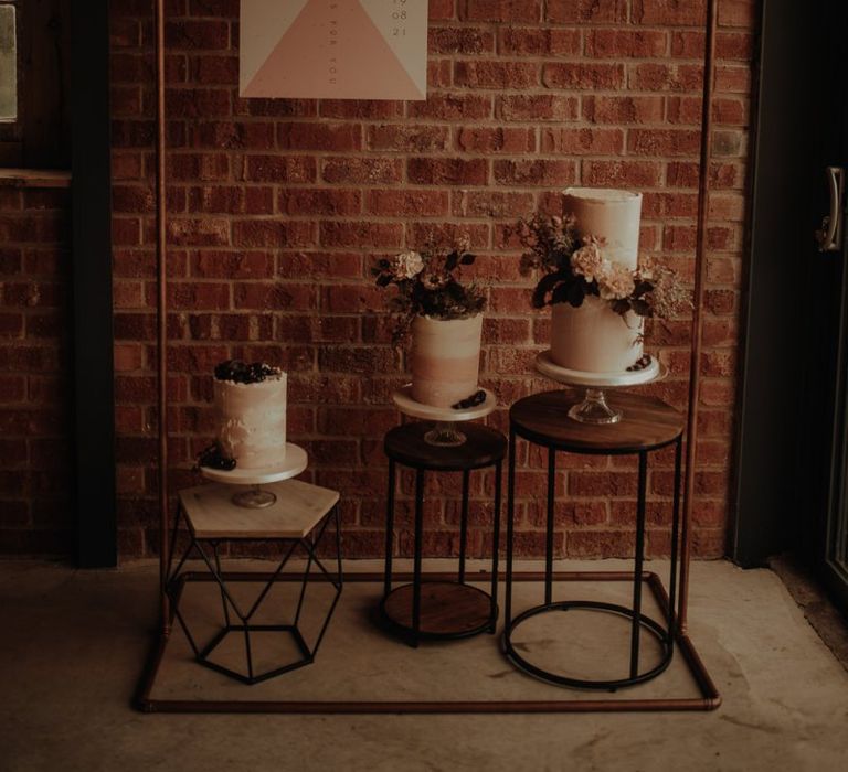 Dessert corner with three wedding cakes  and copper frame