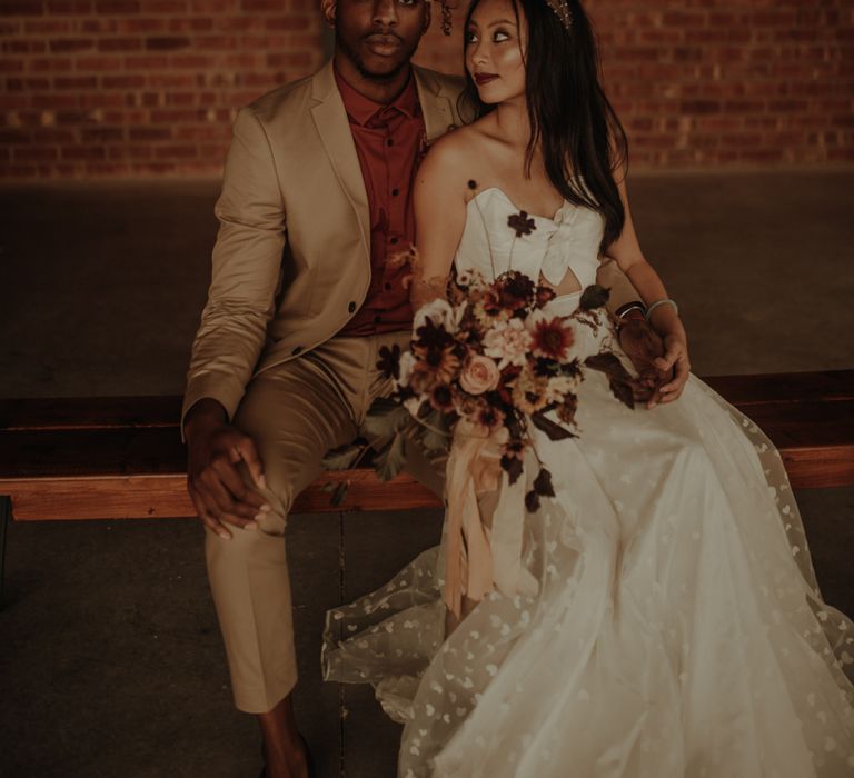 Portrait of groom in beige suit and burgundy shirt and bride in E&amp;W Couture wedding dress by Esme Whiteside Photography