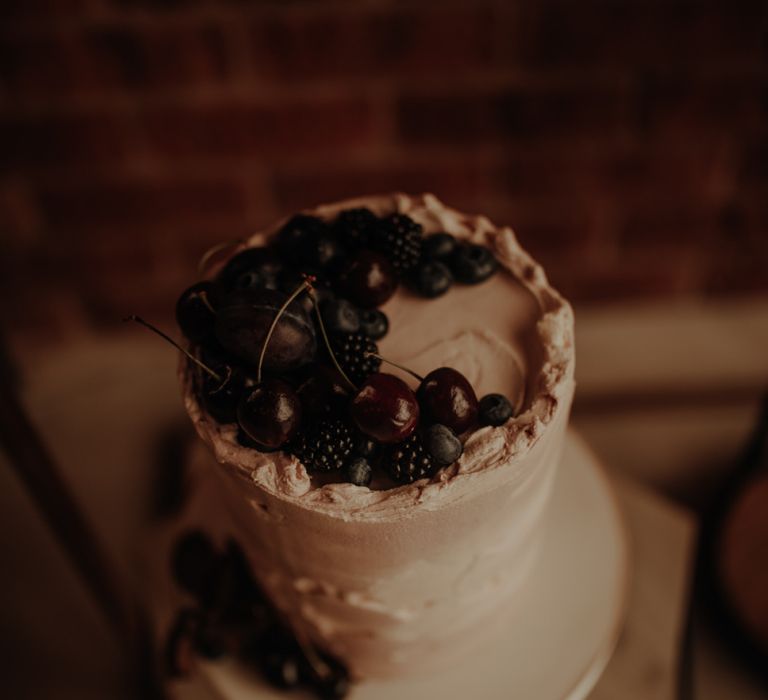 Cherry and blackberry topped wedding cake