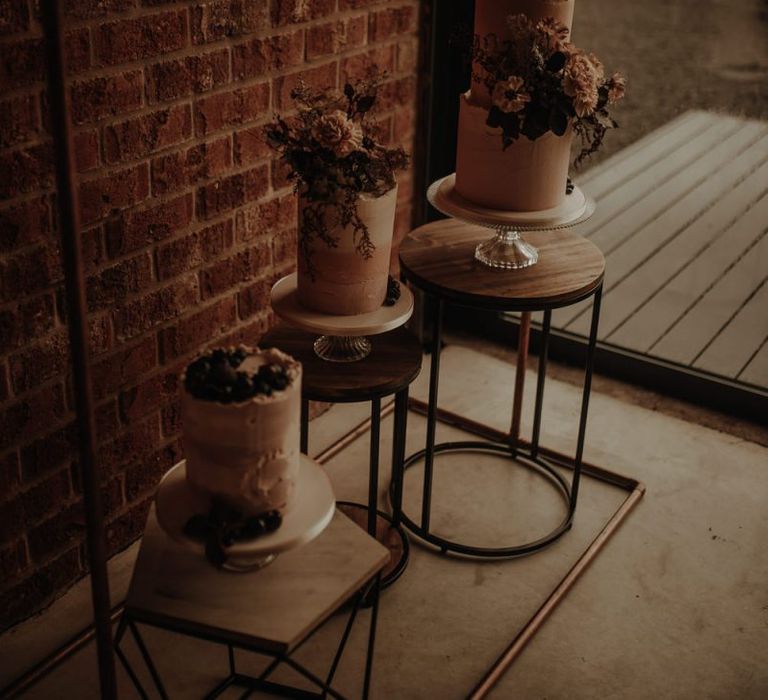 Three individual cakes on cake stands