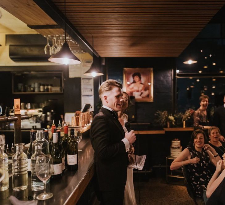 Guests listen to grooms wedding speech