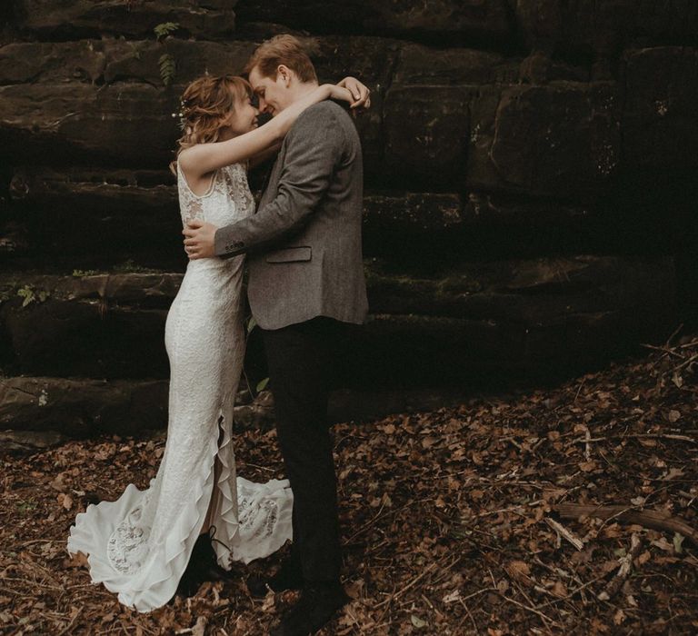 Bride in Lace Wedding Dress with Front Split and Groom in Wool Suit