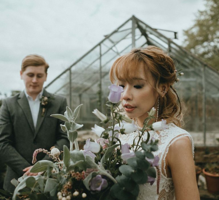 Beautiful Oriental Bride Holding a Wildflower Wedding Bouquet