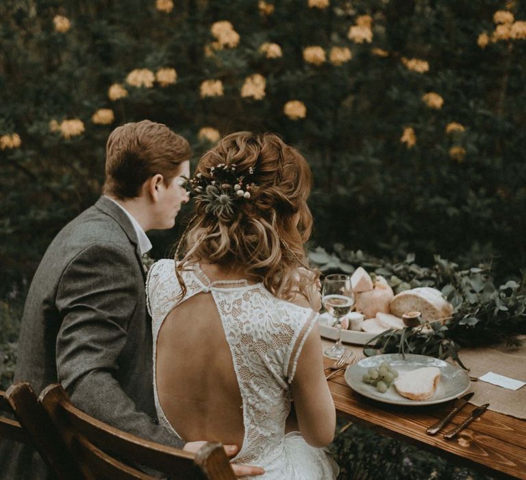 Bride in Lace Keyhole Back Wedding Dress with Half Up Half Down Hairstyle