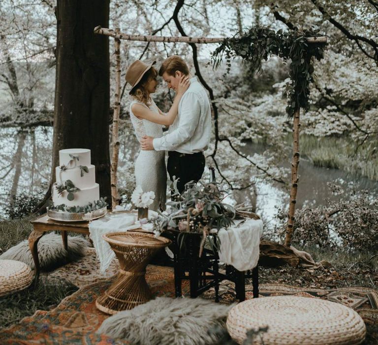 Boho Bride and Groom Standing by Wooden Altar