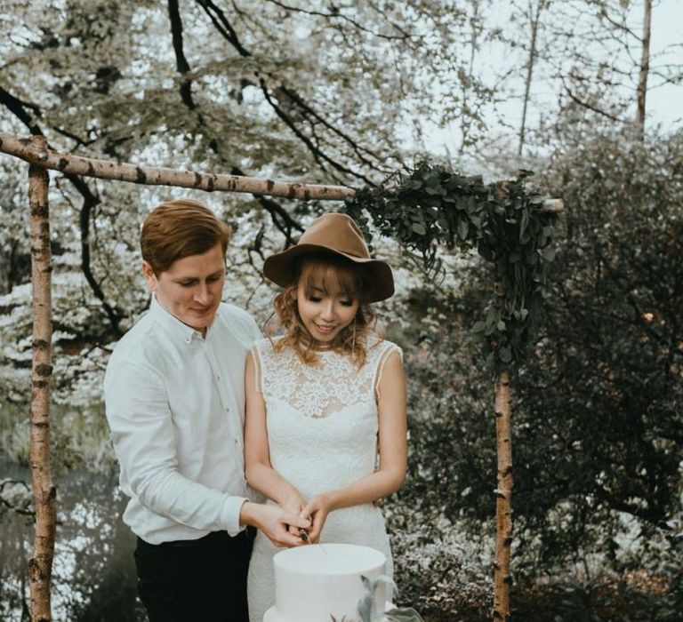 Boho Bride and Groom Cutting the Wedding Cake