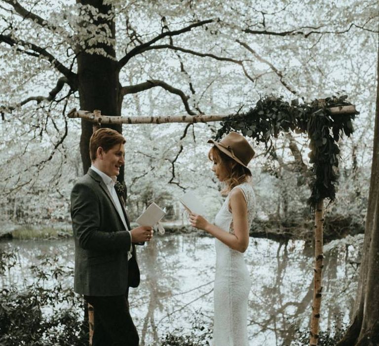 Boho Bride in Lace Wedding Dress and Felt Hat and Groom in Wool Blazer   Exchanging Their  Wedding Vows