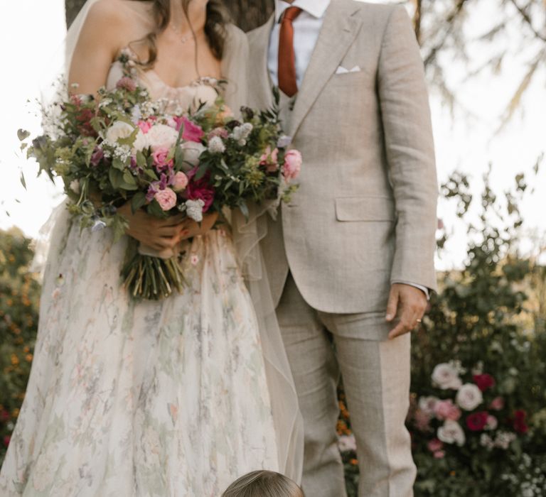 Outdoor Wedding Ceremony | Bride in Strapless Embroidered Wedding Dress by Rara Avis | Groom in Beige Suit with Ochre Tie | Romantic Bridal Bouquet | Flower Girl | Fairytale Tuscan Wedding with Bride in Embroidered Dress | Andrea &amp; Federica Photography