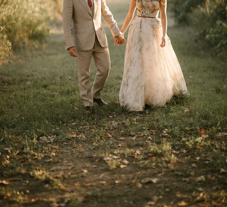 Bride in Strapless Embroidered Wedding Dress by Rara Avis | Groom in Beige Suit with Ochre Tie | Golden Hour | Fairytale Tuscan Wedding with Bride in Embroidered Dress | Andrea &amp; Federica Photography