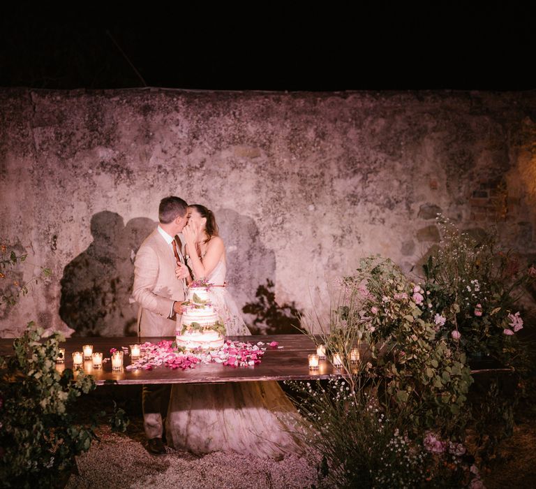 Cake Cutting | Naked Wedding Cake | Pink Petals | Tea Lights | Fairytale Tuscan Wedding with Bride in Embroidered Dress | Andrea &amp; Federica Photography