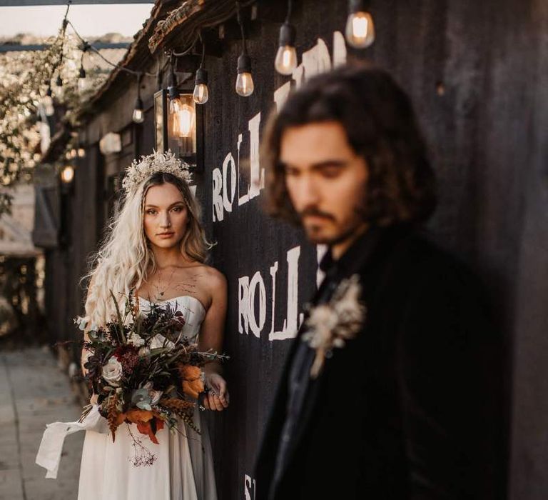 Bride in strapless wedding dress with autumn wedding bouquet for Halloween wedding