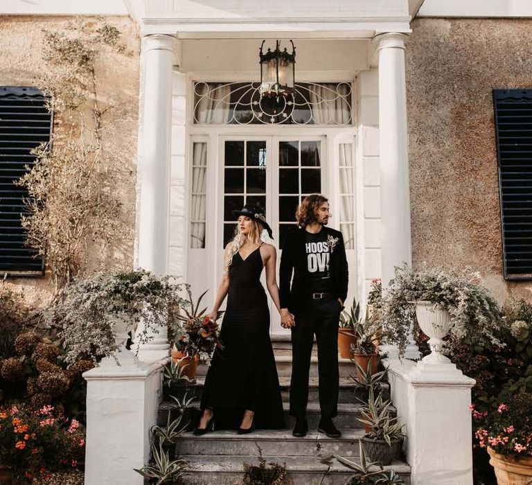 Stylish bride and groom in black wedding dress and t-shirt outside Preston Court