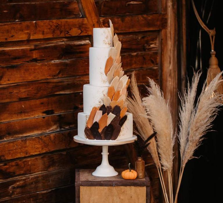 Wedding cake with pumpkins, crates and dried flower Halloween wedding decor