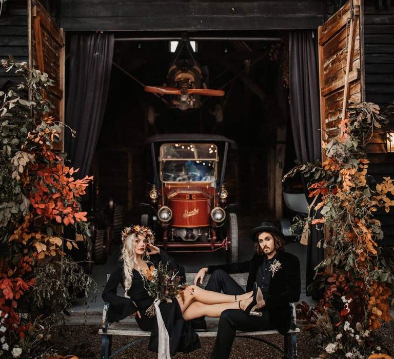 Preston court shed with bride and groom sitting on a bench for Halloween wedding