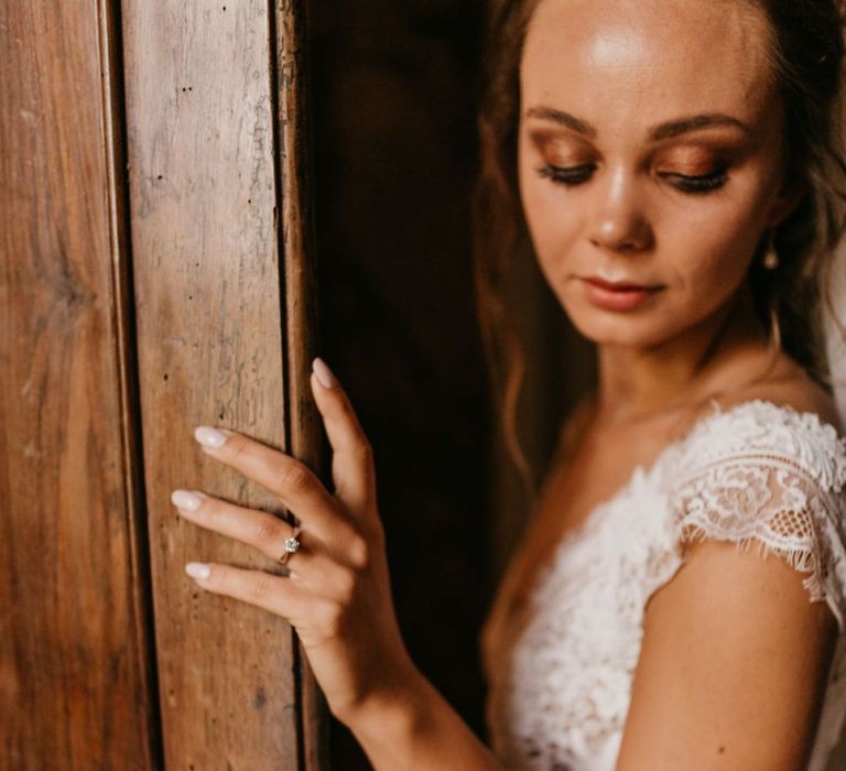 Bride in Bespoke Wedding Dress with Lace Bodice Showing Off Her Diamond Engagement Ring