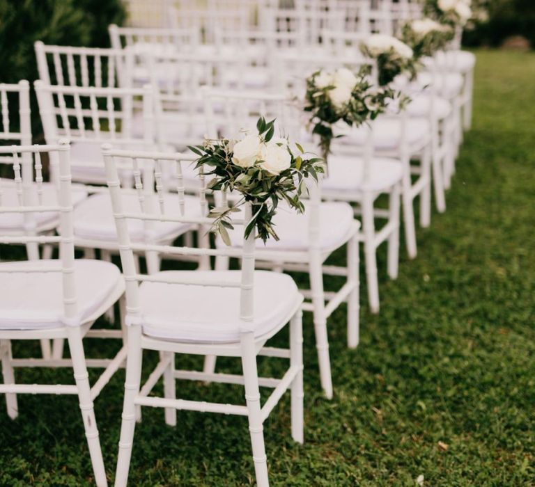 White Ceremony Chairs with Floral Chair Decor