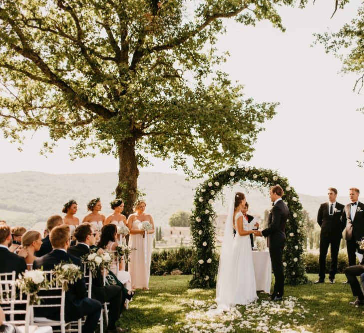 Bride and Groom Exchanging Vows at an Outdoor Wedding Ceremony