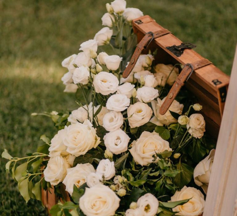 Wooden Trunk Filled with White Roses and Foliage