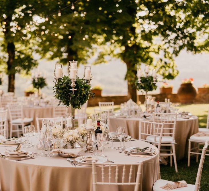 Outdoor Reception with Candelabra Centrepiece Covered in Foliage