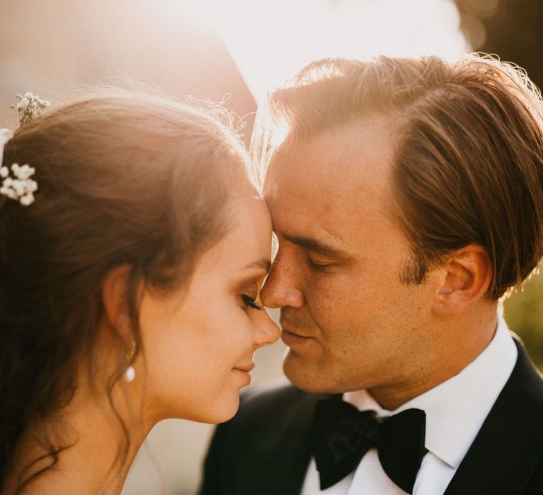 Intimate Golden Hour Portrait with Bride and Groom Embracing