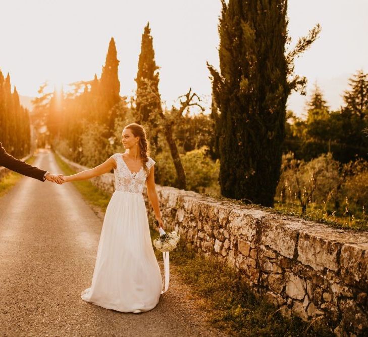 Golden Hour Portrait with Bride in Bespoke Wedding Dress and Groom in Tuxedo and Bow Tie