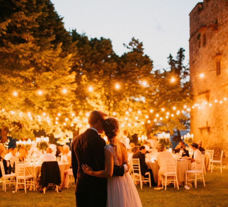 Bride and Groom Embracing at Their Outdoor Italian Castle Wedding Reception