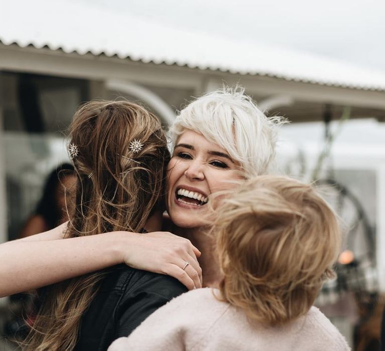 Bride with Short Hair Hugging Wedding Guests