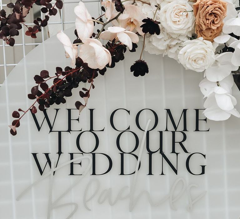 Acrylic Welcome To Our Wedding Sign Decorated with Muted Wedding Flowers