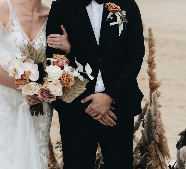 Bride with Short Hair in Made With Love Wedding Dress and Groom in Tuxedo at Beach Wedding Ceremony