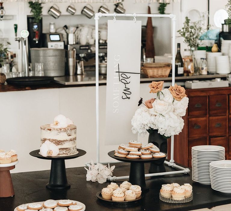 Dessert Table with Individual Cakes and Something Sweet Contemporary Wedding Sign  on Metal Frame