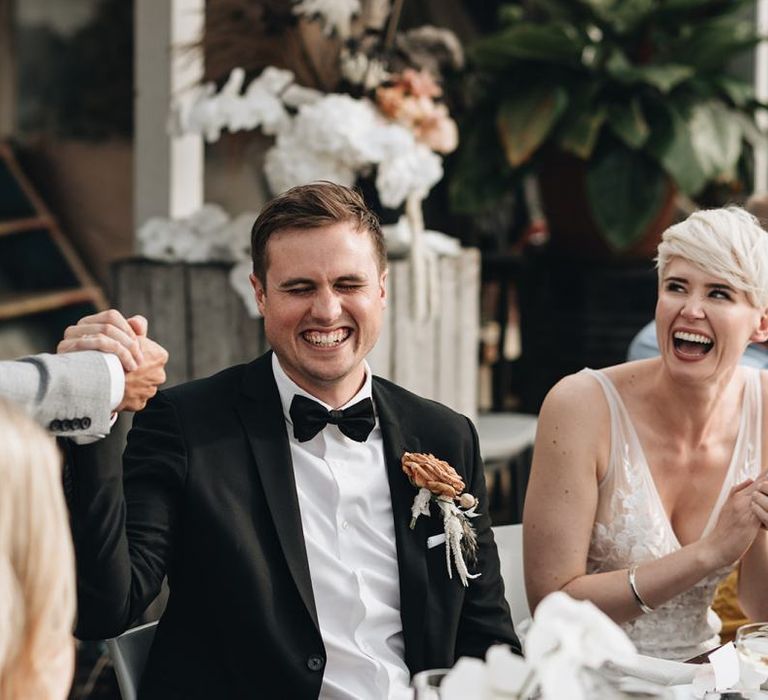 Bride and Groom Laughing During Wedding Reception Speeches