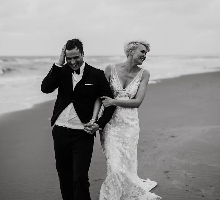 Portrait of Bride and Groom Walking Along the Beach