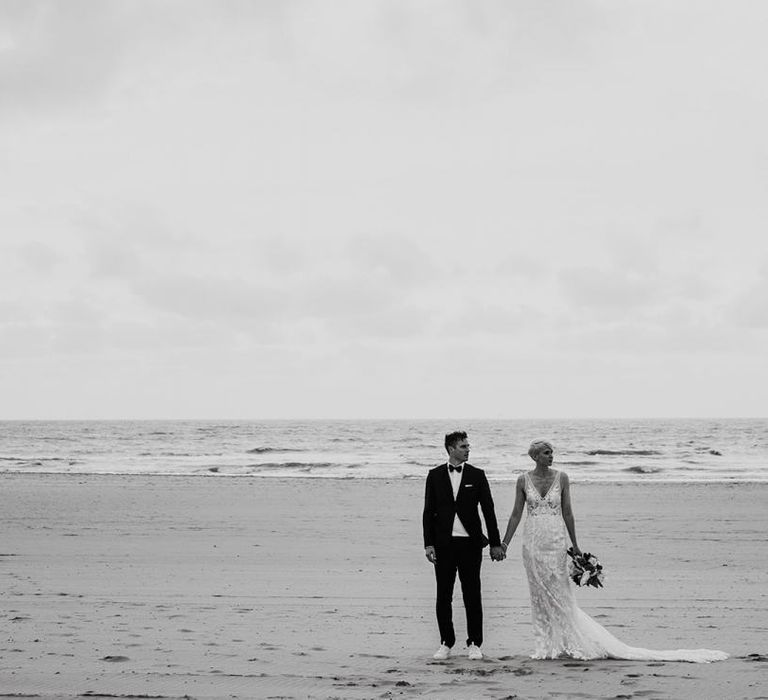 Bride and Groom Standing in the Surf on the Beach