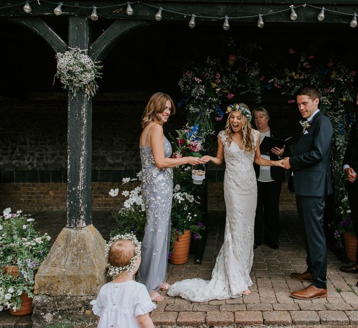 Wedding Ceremony with Bride in Lace Watters Wedding Dress and Groom in Navy Hugo Boss SuitStanding at the Altar