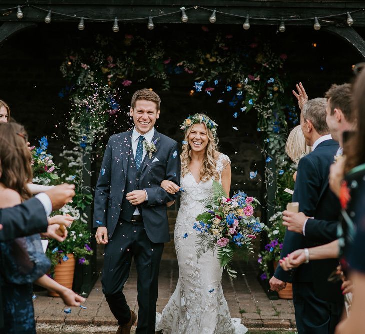 Confetti Exit with Bride in Lace Watters Wedding Dress and Groom in Navy Hugo Boss Suit