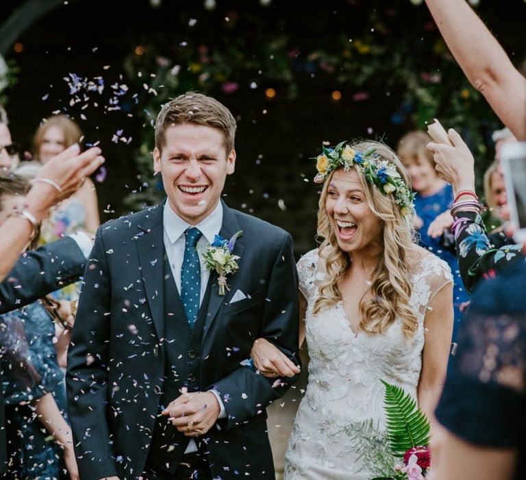 Confetti Moment with Bride in Lace Watters Wedding Dress and Groom in Navy Hugo Boss Suit