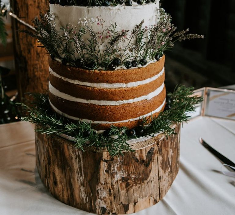 Rustic Naked and Semi Naked Wedding Cake on Tree Trunk Cake Stand Decorated with Wildflowers