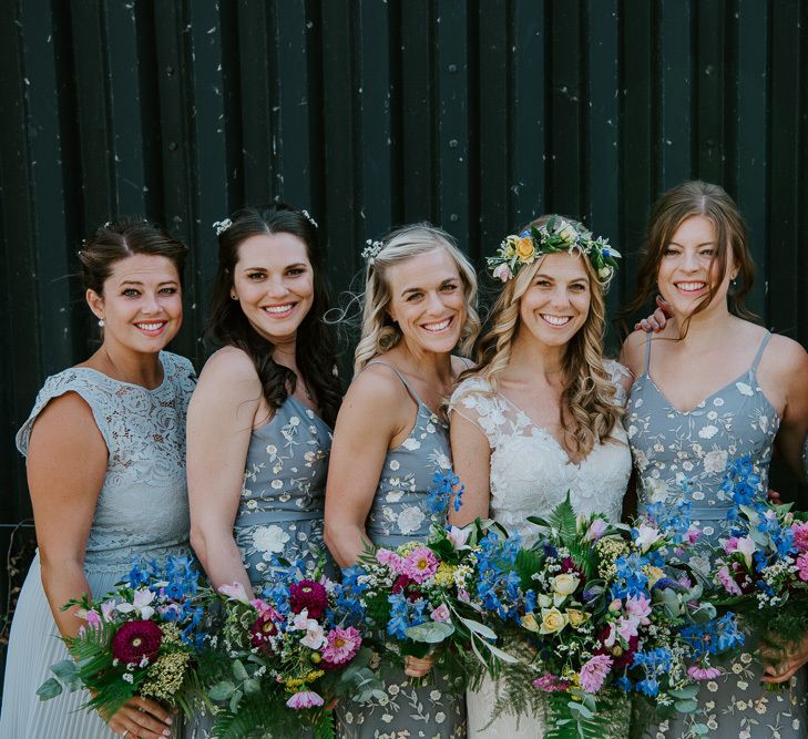 Bridal Party Portrait with Bridesmaids in Blue Floral and Blue Lace Oasis and ASOS Dresses and Bride in Lace Watters Wedding Dress with Flower Crown