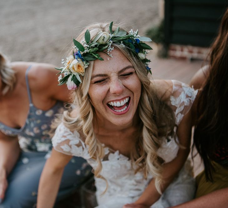 Freckly Bride with Curly Hair and Flower Crown Laughing with her Girlfriends