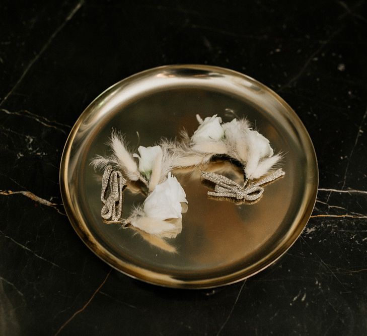 White Rose and Feather Buttonholes on a Gold Platter