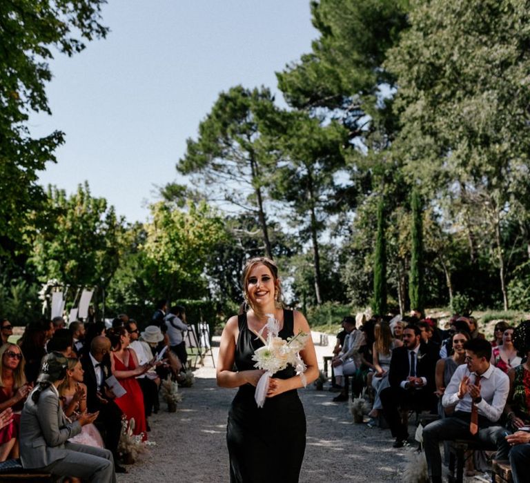 Bridesmaid in Fitted Black Dress Walking Down the Aisle