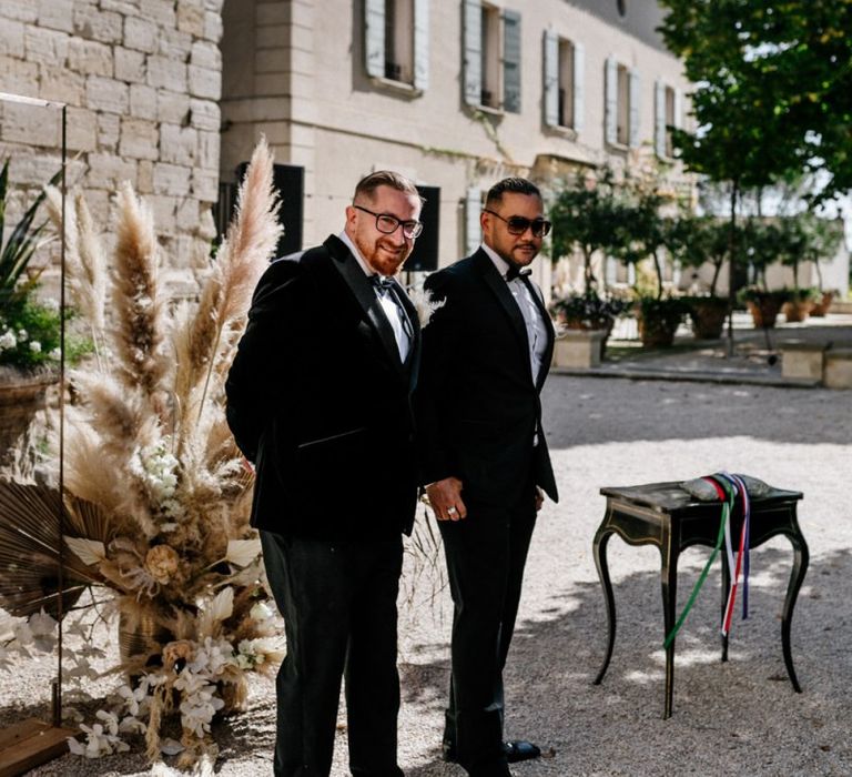 Groom and Best Man in Tuxedos Standing at the Altar