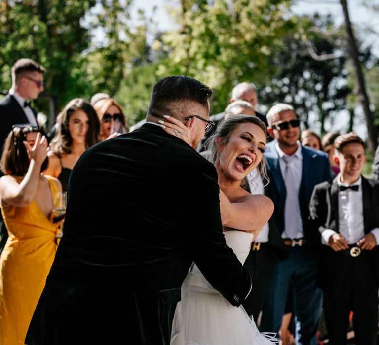 Groom Embracing His Surprised Bride