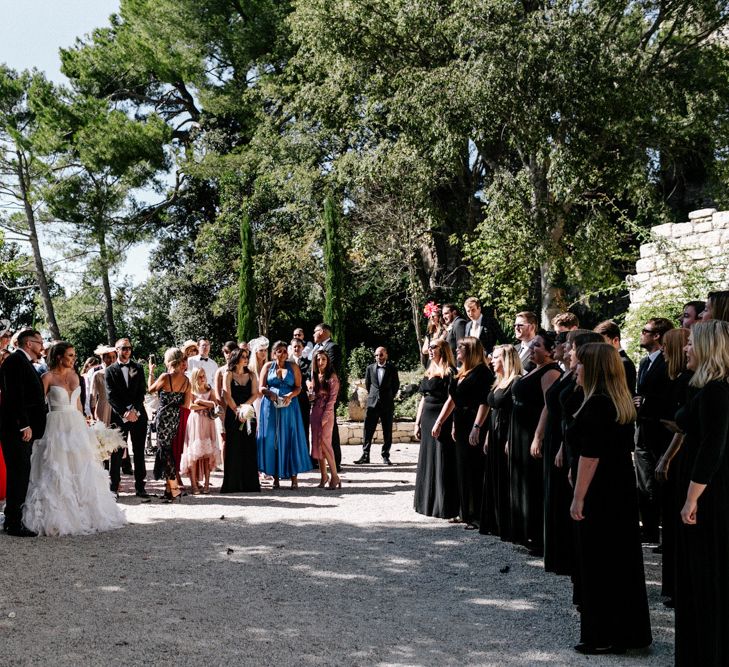 Bride and Groom and Wedding Guests Listening to the Choir