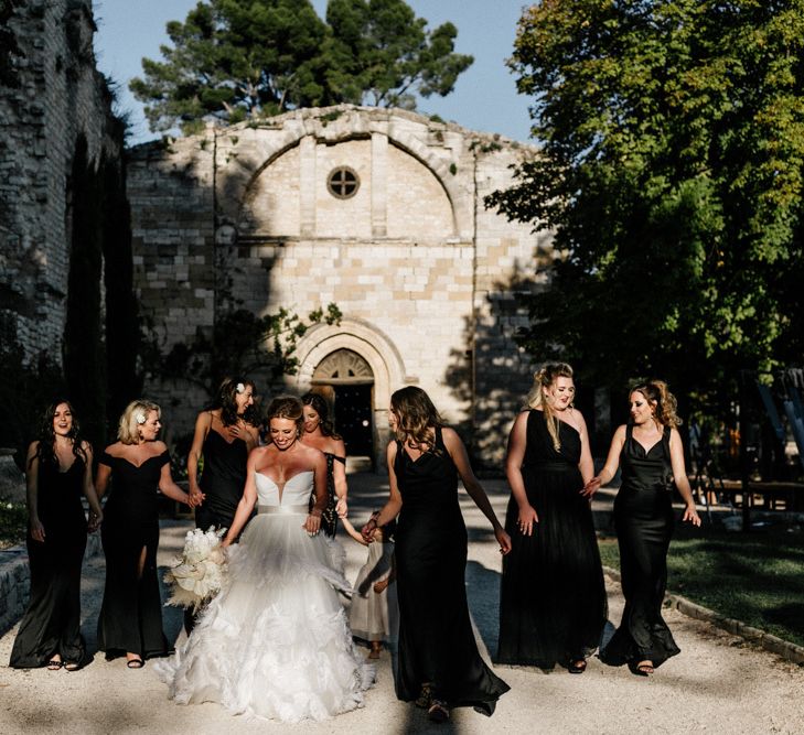 Stylish Bridal Party with Bridesmaids in Black Dresses and Bride in Feather Skirt Wedding Dress