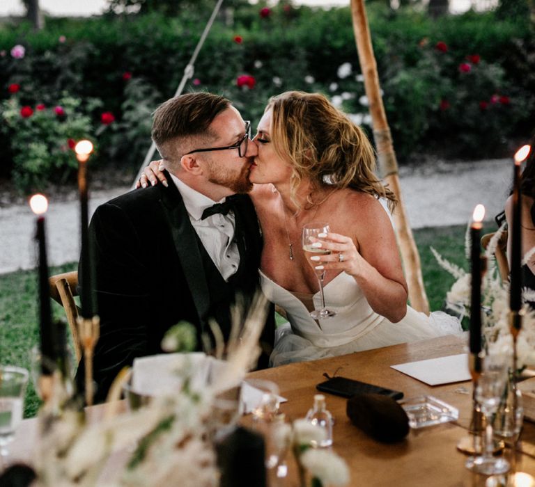 Bride and Groom Kissing at the Wedding Breakfast