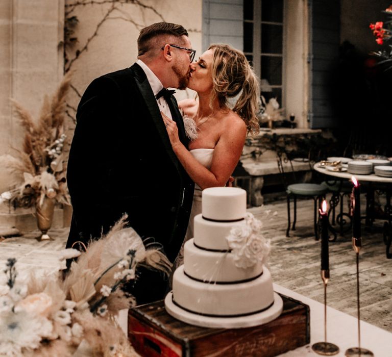 Bride and Groom Kissing After they Cut The Wedding Cake