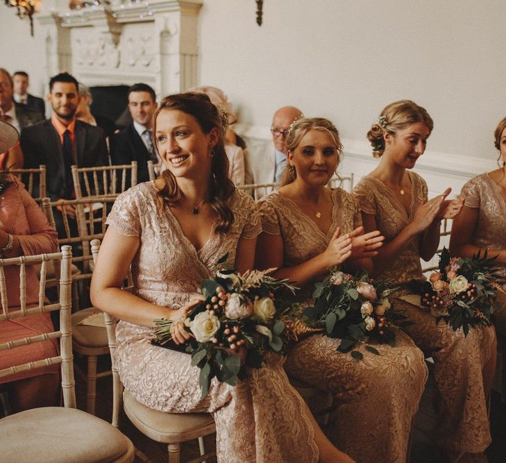 Bridesmaids During Ceremony In Pink Dresses