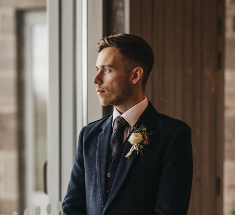 Groom in a kilt waits for his bride