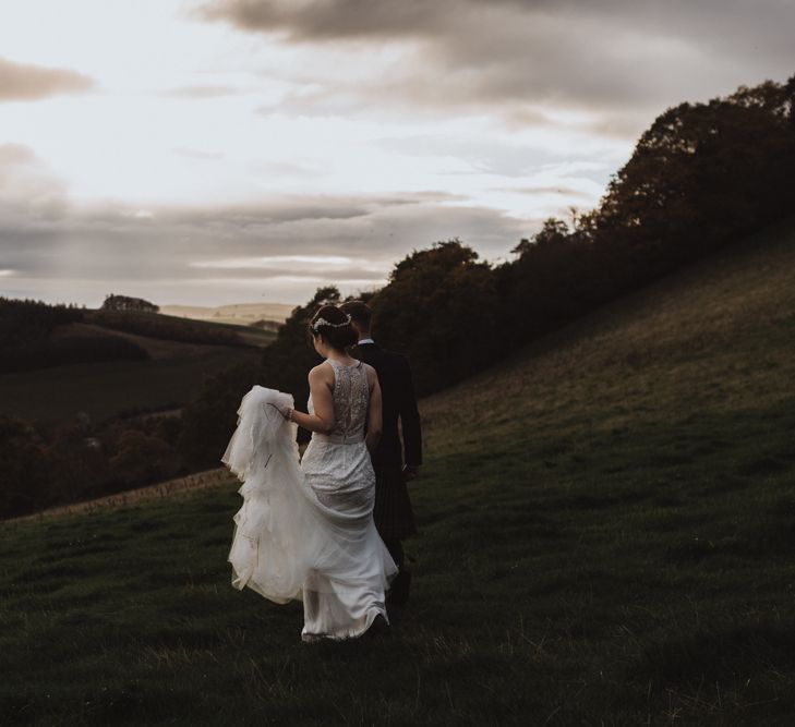 Bride and groom take a walk over Guardswell Farm fields